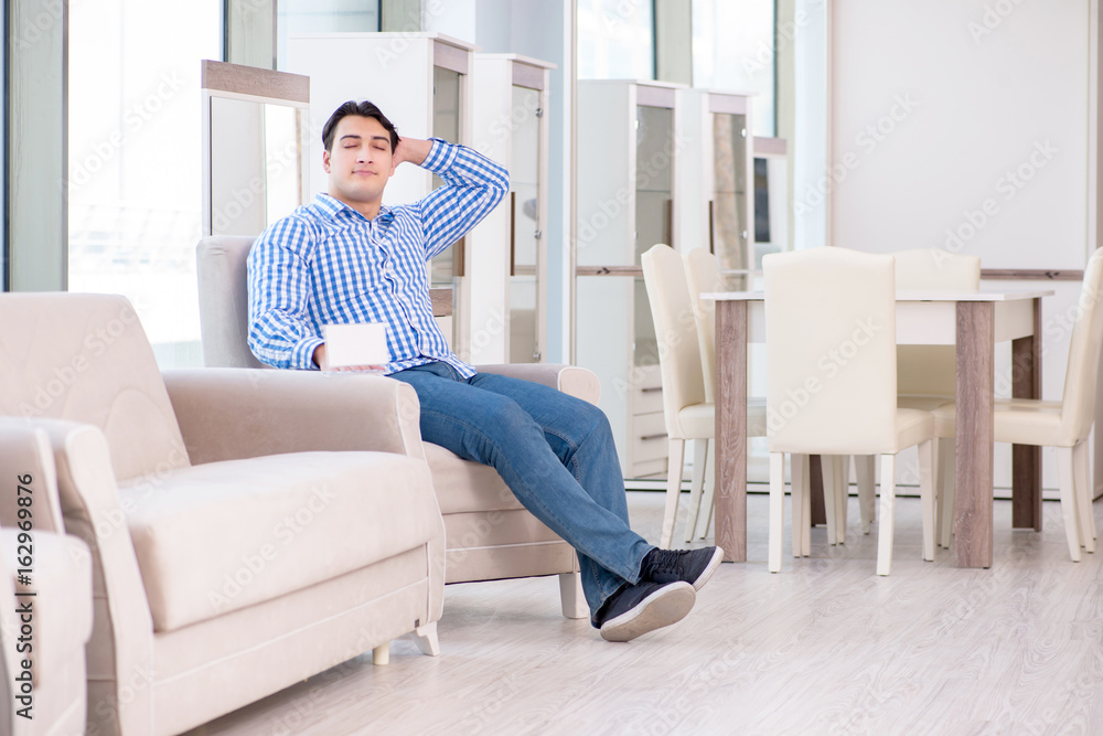 Young man shopping in furniture store Young man shopping in furniture store