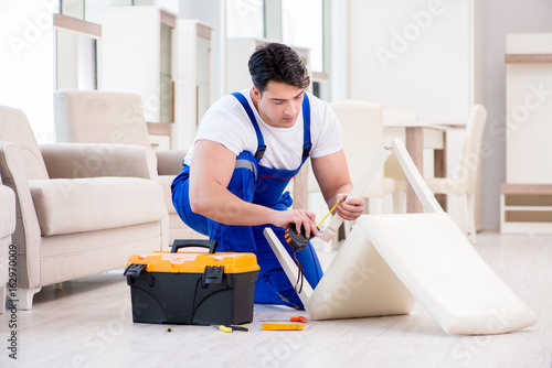 Furniture repairman working in store