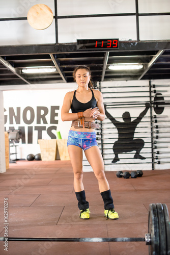 Girl standing infront of weights