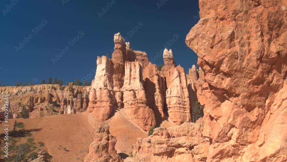 CLOSE UP: Stunning eroded red rock landscape in Bryce Canyon National Park in gorgeous sunny day. Beautiful sandstone pillar and hoodoo formations against the blue sky at red sand desert in Utah, USA CLOSE UP: Stunning eroded red rock landscape in Bryce Canyon National Park in gorgeous sunny day. Beautiful sandstone pillar and hoodoo formations against the blue sky at red sand desert in Utah, USA