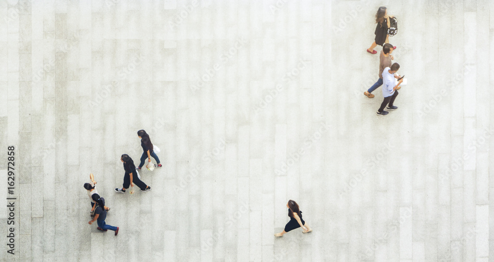Obraz premium top aerial view of people walk and stand on pedestrian walkway.