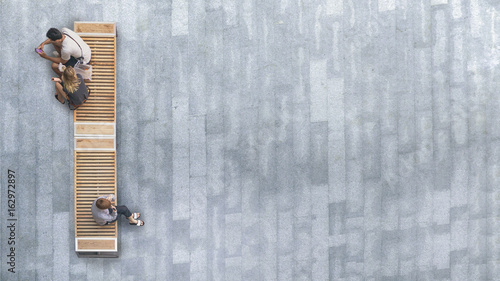 top aerial view of people sit on wood bench at the upper floor pedestrian.