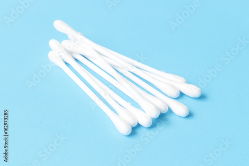 Cotton buds on light blue background  health care concept