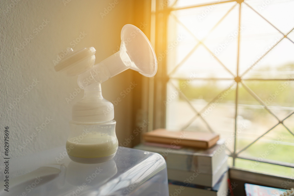 Automatic breast pump, mothers breasts milk is the most healthy food for newborn baby in bed room at home,vintage color Automatic breast pump, mothers breasts milk is the most healthy food for newborn baby in bed room at home,vintage color