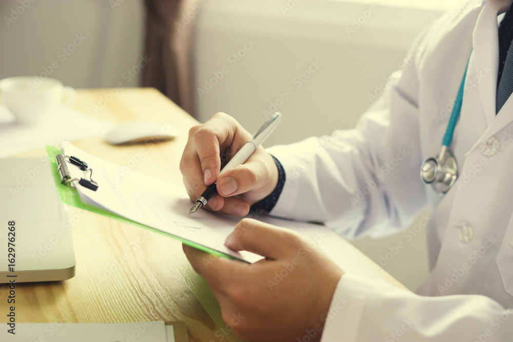 male doctor with stethoscope holding clipboard and writing a prescription,pharmacist working at the hospital or drug store ,pharmacy,Healthcare and medical concept,selective focus male doctor with stethoscope holding clipboard and writing a prescription,pharmacist working at the hospital or drug store ,pharmacy,Healthcare and medical concept,selective focus