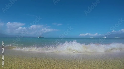 Low Angle POV Shot, Wave Crashes On Beach And Rolls Over Camera's Lens, Bubbles And Sand Swirl In Front Of Lens