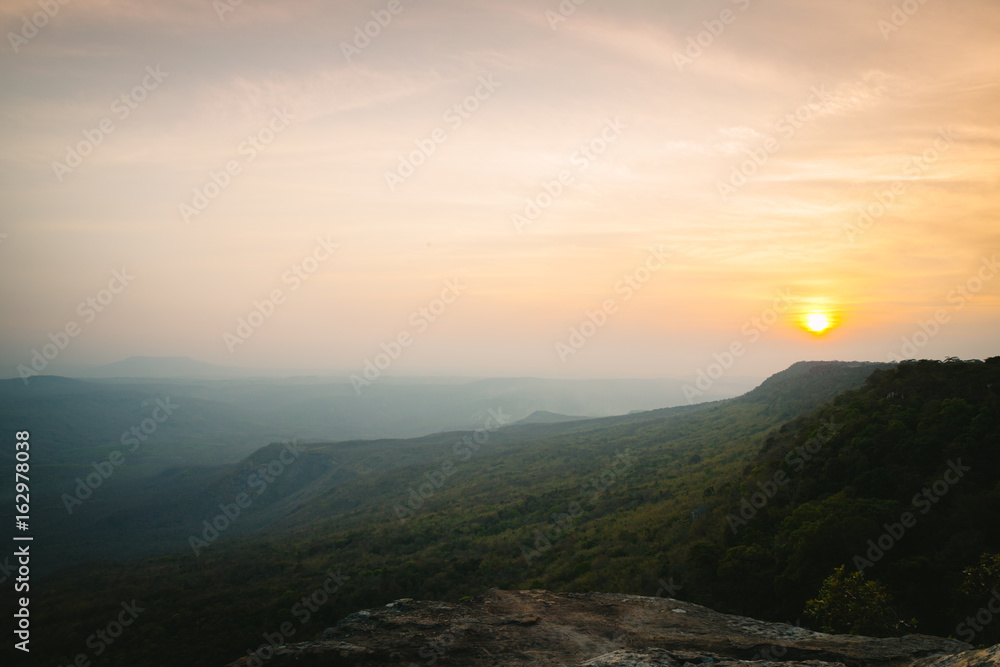 Sunset scene with pine forest and mountain in Pha Mak Duk, Phu Kradueng National Park, Thailand.