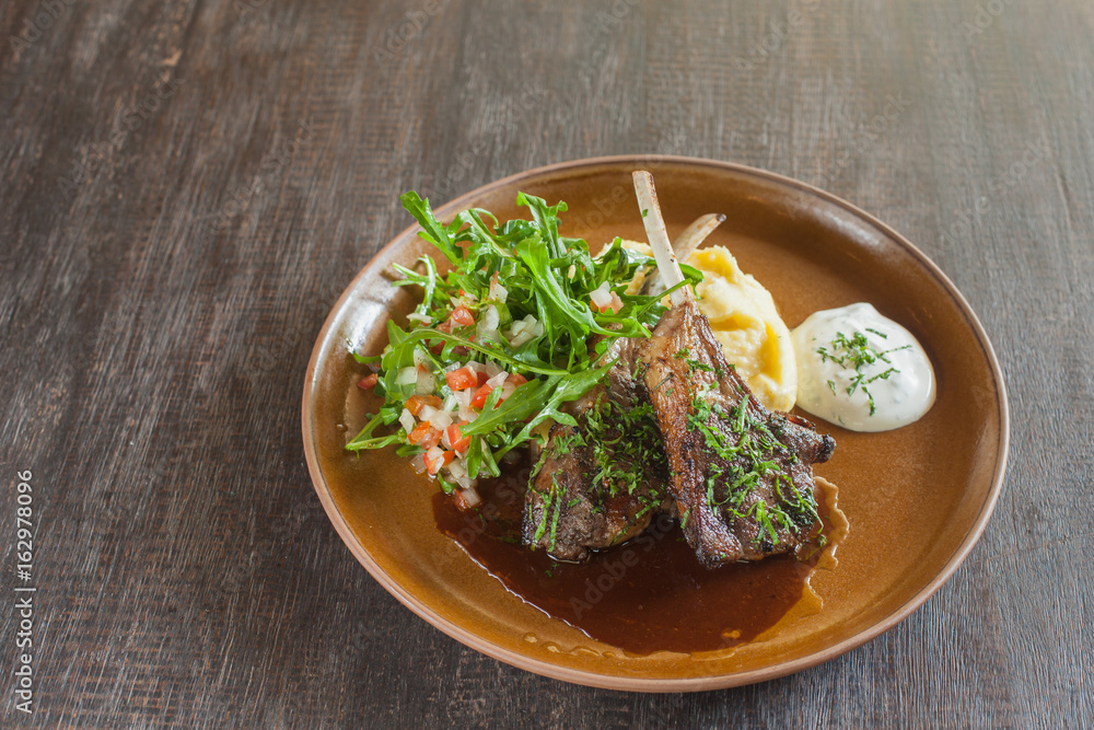Grilled lamb with mash potato and arugula salad. Grilled lamb with mash potato and arugula salad.