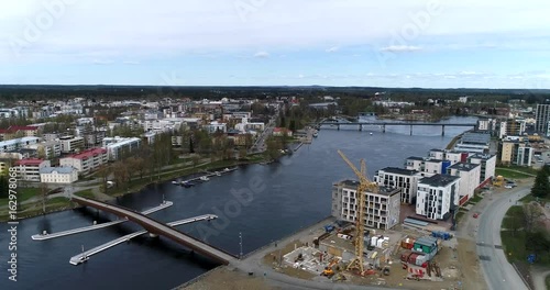 Joensuu, Cinema 4k aerial landing view of joensuu cityscape and pielisjoki river, on a sunny summer day, in Turku, Finland photo