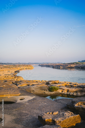 Boat docked in Mekong river near Sam Pan Bok canyon in Ubon Ratchathani , Thailand. photo