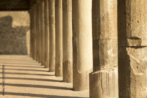 Pillars casting shadows in the evening in ancient city pompeii with copyspace.