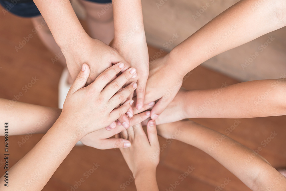 School kid volunteer's hands for public services and successful community sustainability goal concept School kid volunteer's hands for public services and successful community sustainability goal concept