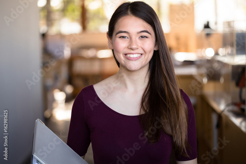 Obraz na plátně Brunette multiracial asian millennial university student on her way to class