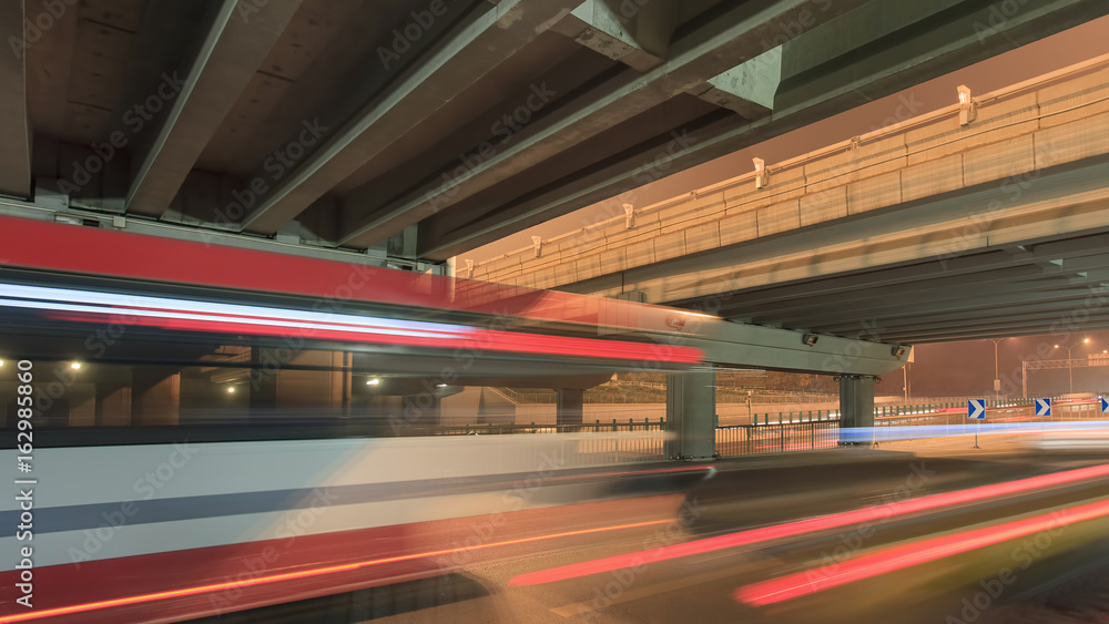 Traffic in motion blur at underpass at night in Beijing, China