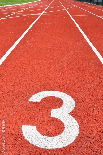Running track with number 3. Colorful background for sport. © montypeter