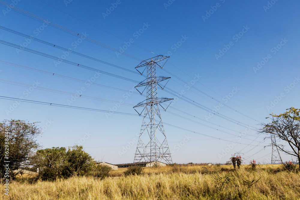 Electric Powerlines and Pylons on Winter Landscape