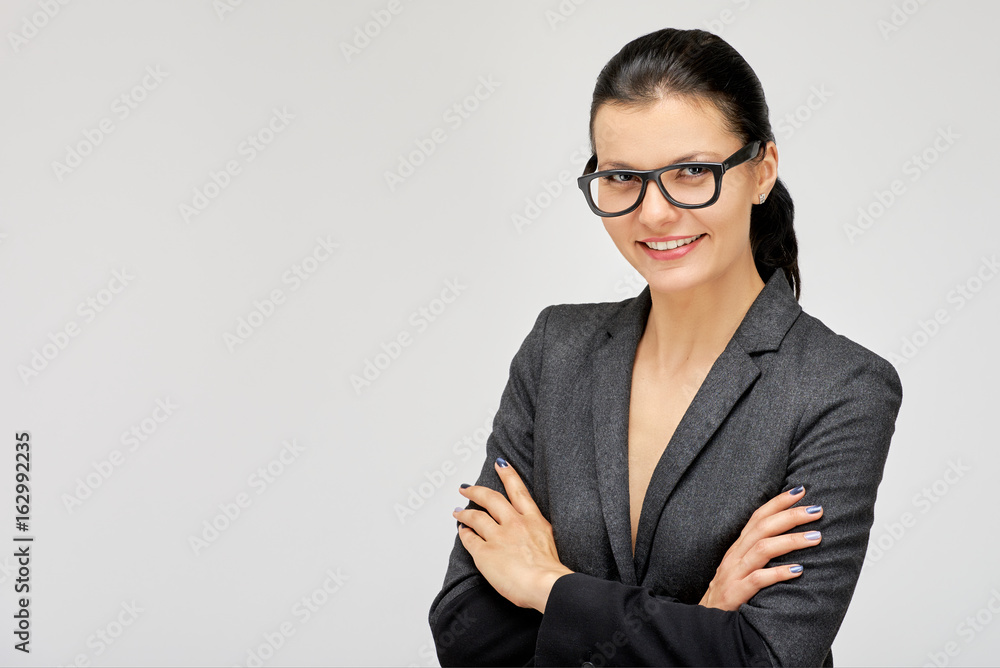 Portrait of smiling business woman on gray background Portrait of smiling business woman on gray background