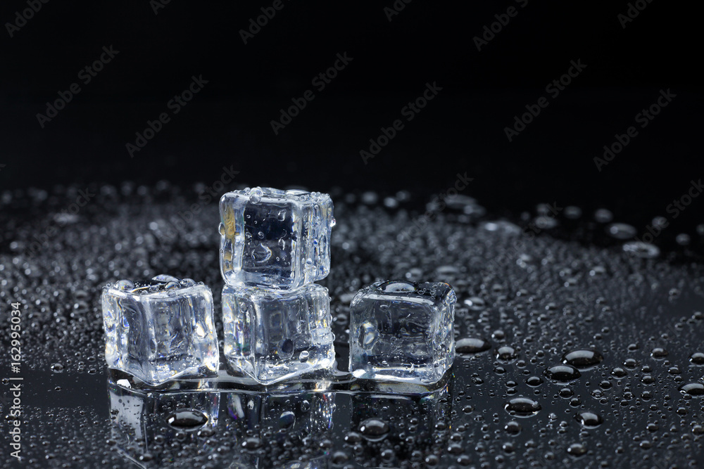 Wet ice cubes and water drop on black background. Wet ice cubes and water drop on black background.