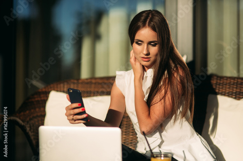Young beautiful girl use a laptop during a break at work.