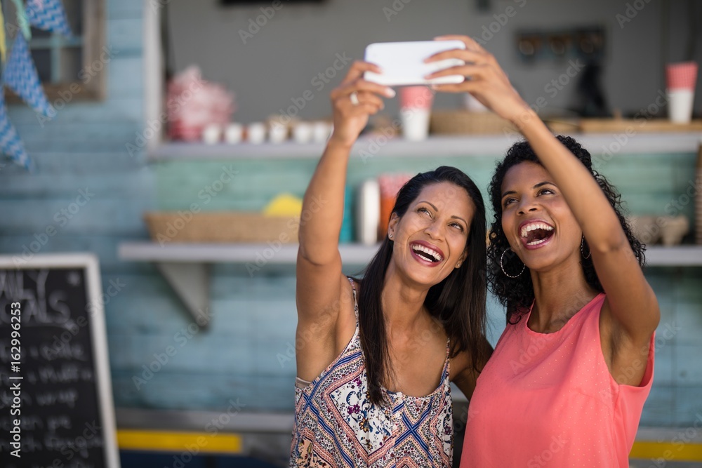 Fotografie Friends taking selfie from mobile phone