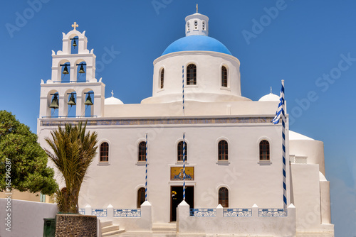 Typical Greek island church with white bell tower and blue dome