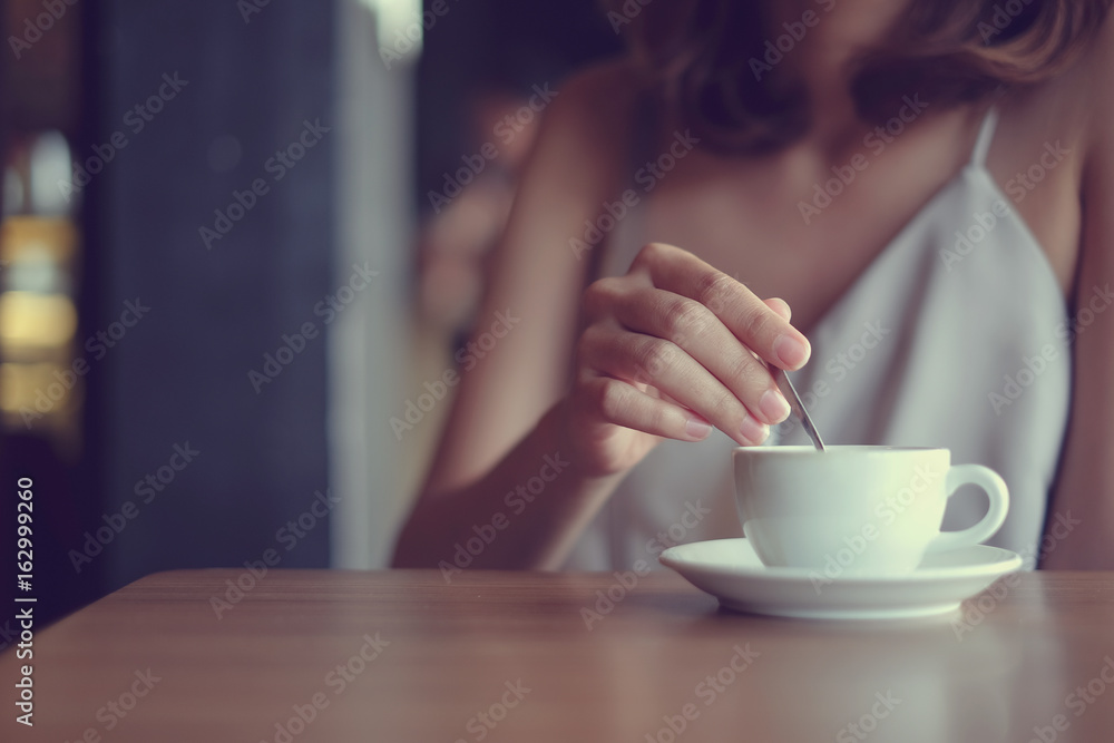 close up asian woman using little spoon brewing hot coffee for good taste in coffee bar shop,modern life style,hipster girl concept,vintage color filter close up asian woman using little spoon brewing hot coffee for good taste in coffee bar shop,modern life style,hipster girl concept,vintage color filter