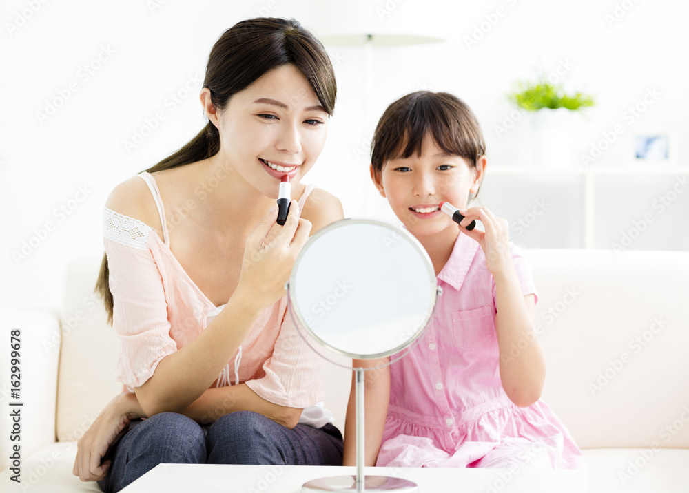 happy Mother and little girl doing your makeup happy Mother and little girl doing your makeup