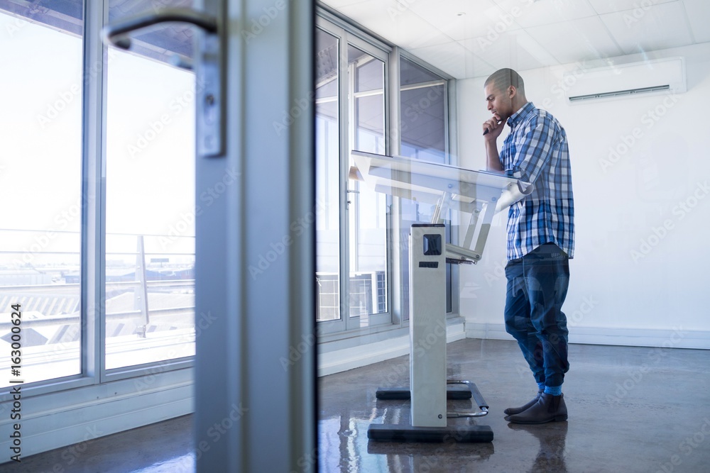Male executive working over drafting table Male executive working over drafting table