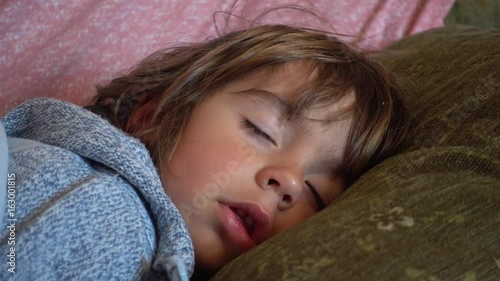 4K Adorable child sleeps with open mouth and stuffy nose