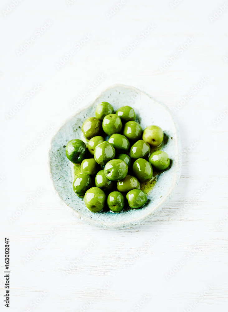 Organic Green Olives on a Ceramic Plate Organic Green Olives on a Ceramic Plate