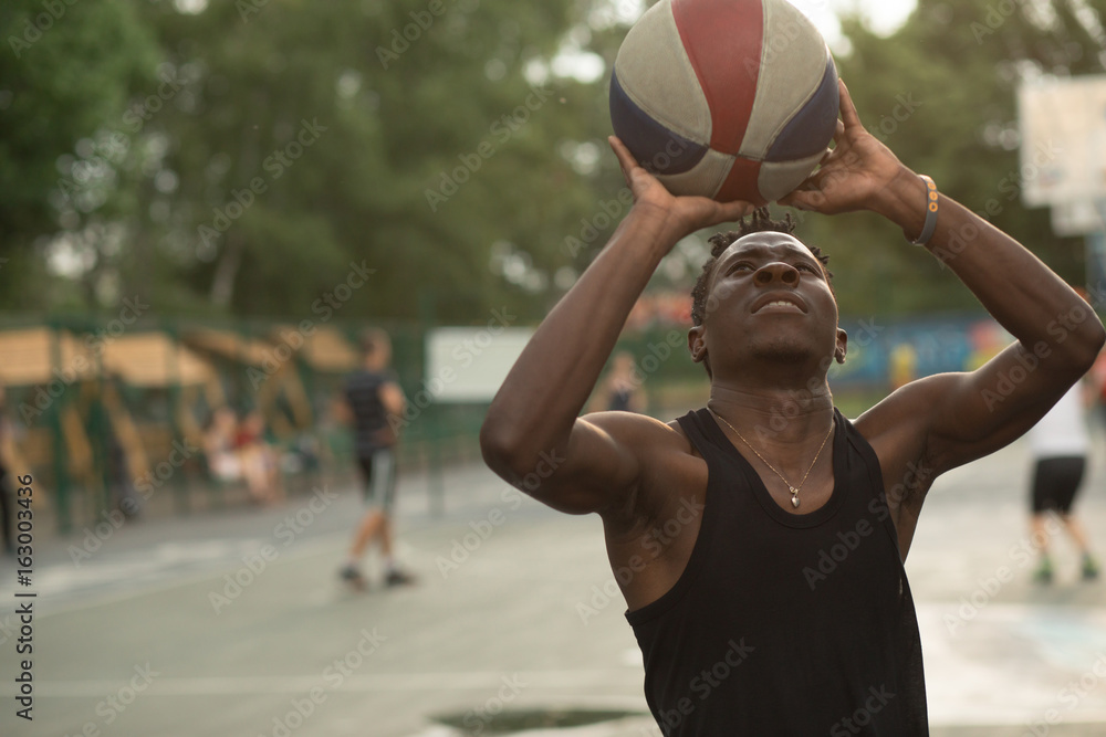 African american man plays on street basketball court. Real and authentic activity. African american man plays on street basketball court. Real and authentic activity.