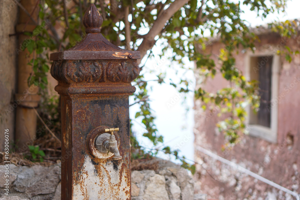 Old rusty water column in Forza d'Agro, Sicily Old rusty water column in Forza d'Agro, Sicily