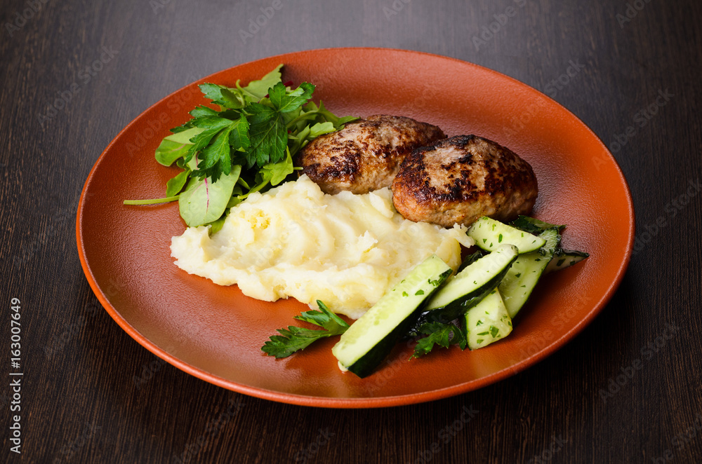 Patties with puree on plate, view from above Patties with puree on plate, view from above
