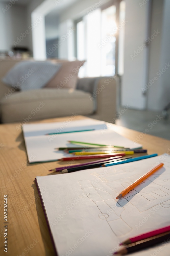 Books and pencils on a table in the living room Books and pencils on a table in the living room