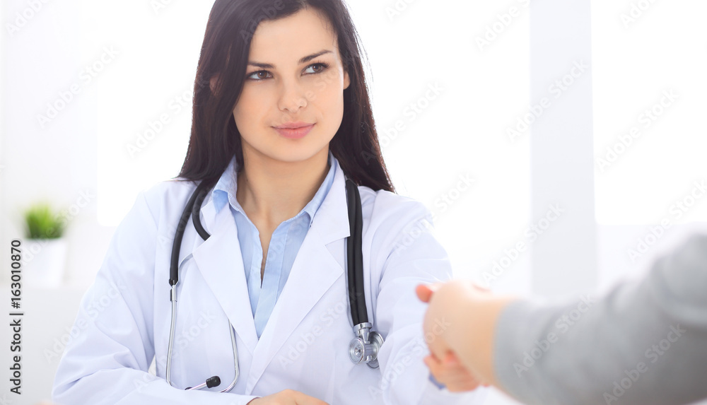Doctor and patient shaking hands to each other. Healthcare, medicine and trusting concept. Doctor and patient shaking hands to each other. Healthcare, medicine and trusting concept.