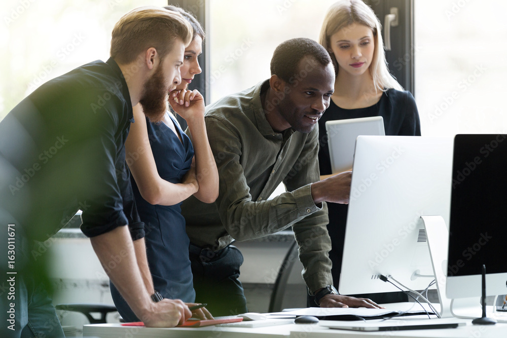Group of young businesspeople in a meeting at office Group of young businesspeople in a meeting at office