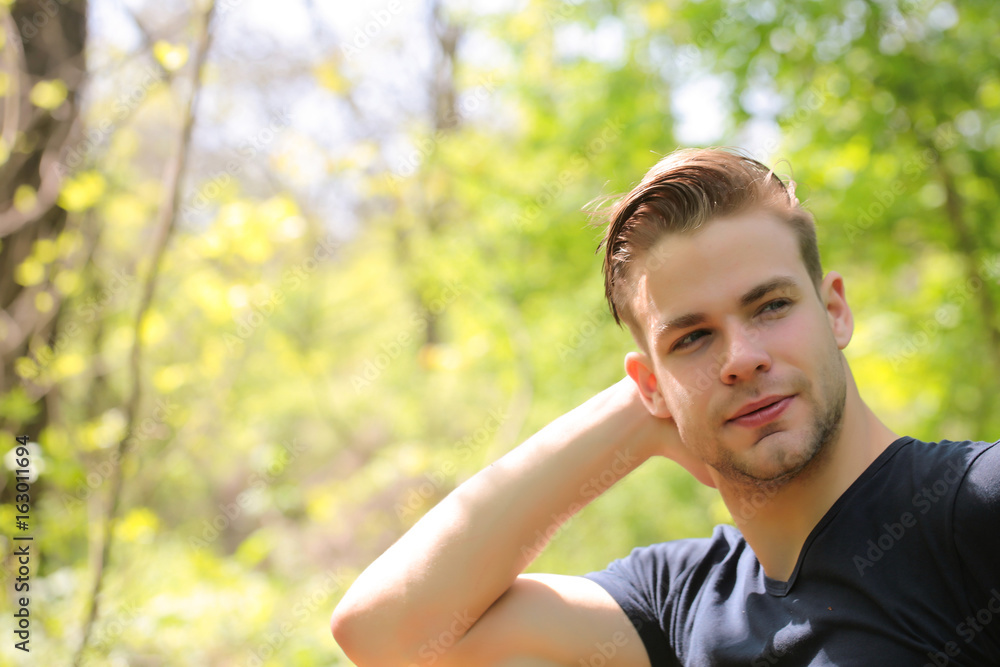 Happy young man with smile, stylish haircut and facial hair