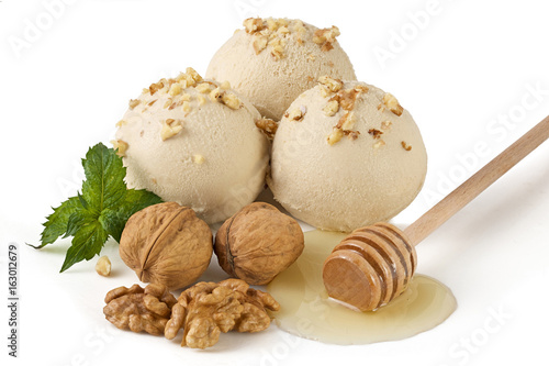 Three scoops of ice cream with honey and walnut flavor isolated with clipping path photo