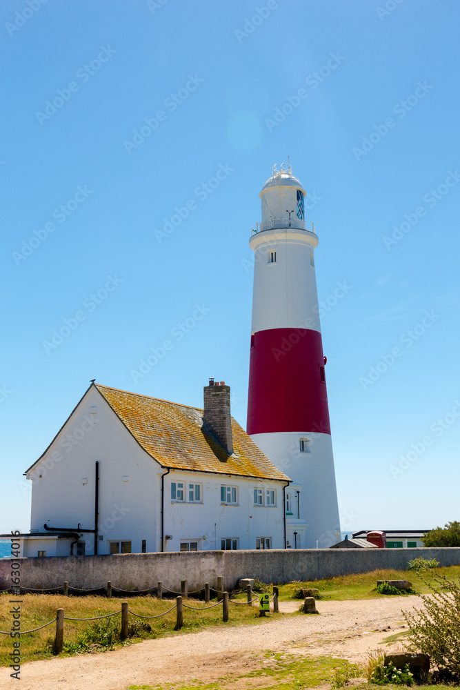 Portland Bill Lighthouse on Portland rocks in sunny summer day