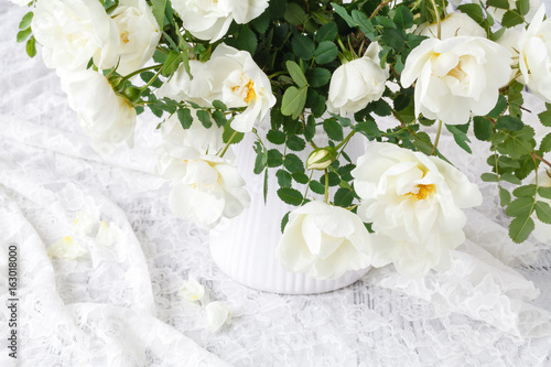 bouquet of beautiful wild roses on white background