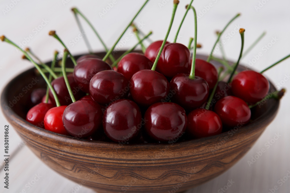 Sweet fresh cherries on white wood background Sweet fresh cherries on white wood background