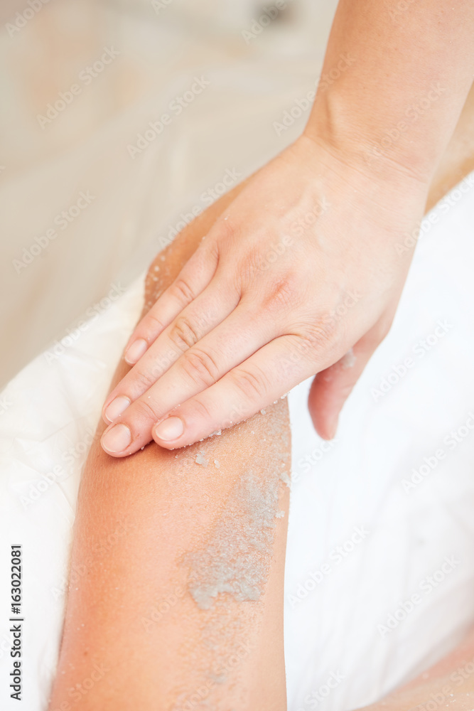 Woman Getting a Salt Scrub Beauty Treatment in the Health Spa Woman Getting a Salt Scrub Beauty Treatment in the Health Spa