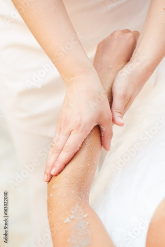 Woman Getting a Salt Scrub Beauty Treatment in the Health Spa