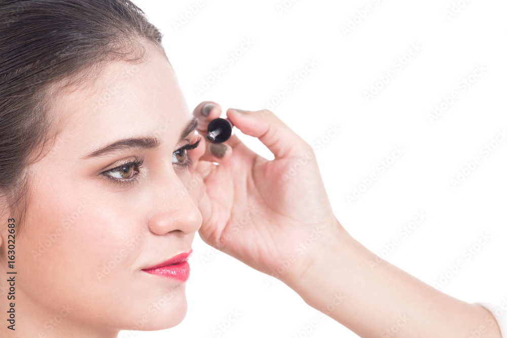 Stylist applying mascara on eyelashes with makeup brush to the beautiful woman Stylist applying mascara on eyelashes with makeup brush to the beautiful woman