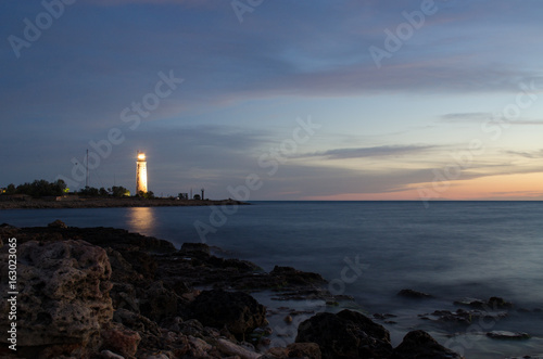 Old lighthouse at sunset © Gennadiy