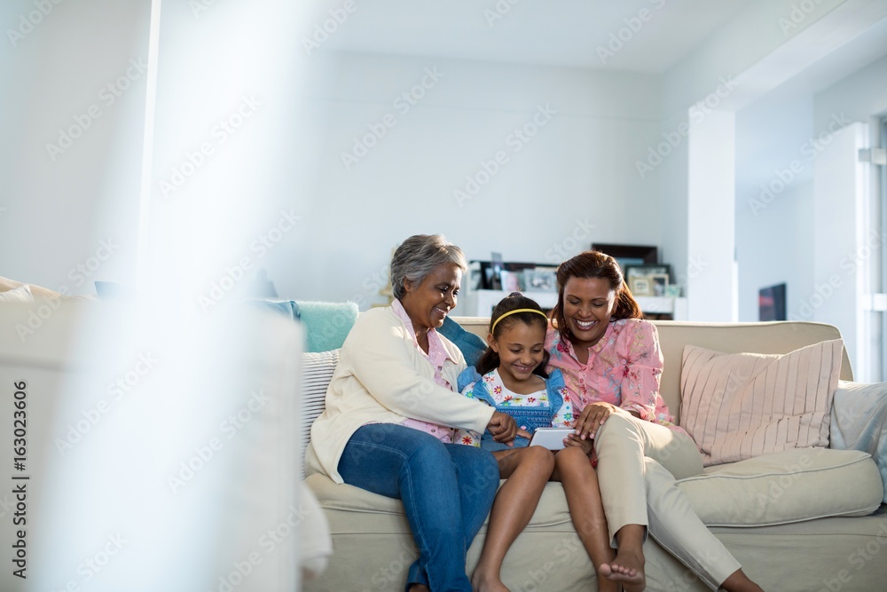 Happy family using mobile phone in living room Happy family using mobile phone in living room