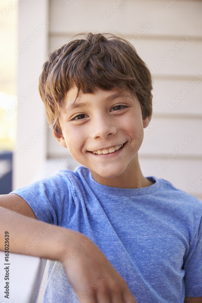 Head And Shoulders Portrait Of Boy Outside House Head And Shoulders Portrait Of Boy Outside House