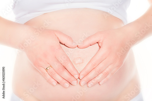 Wallpaper Mural Pregnant woman touching her belly, forming a heart shape. Torontodigital.ca