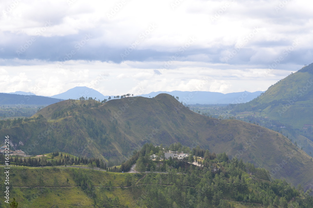 Green mountains under white clouds Green mountains under white clouds