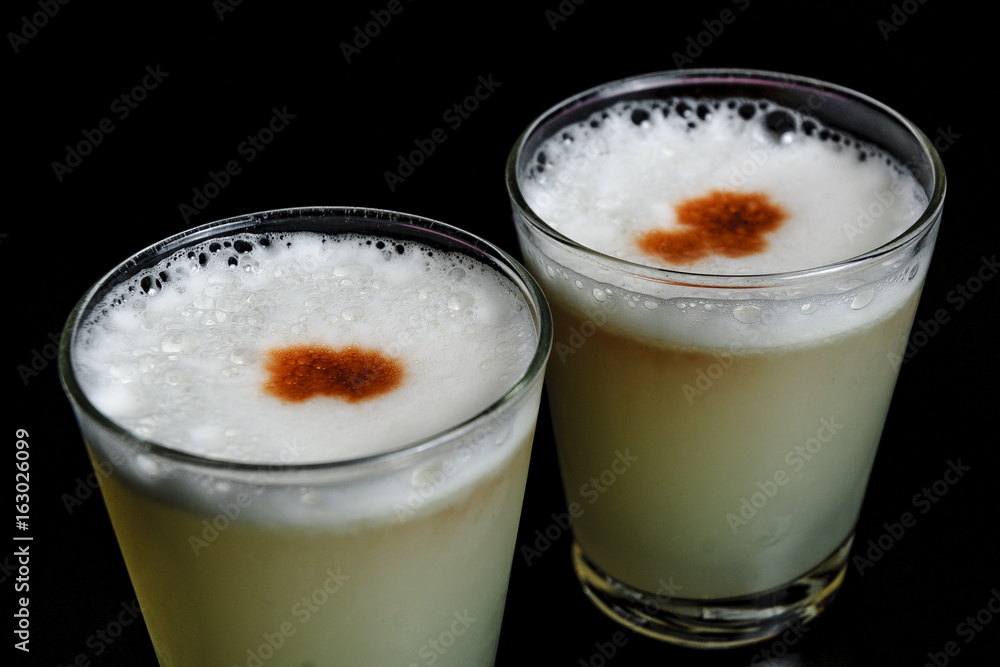 two glasses of cocktail pisco sour two glasses of cocktail pisco sour